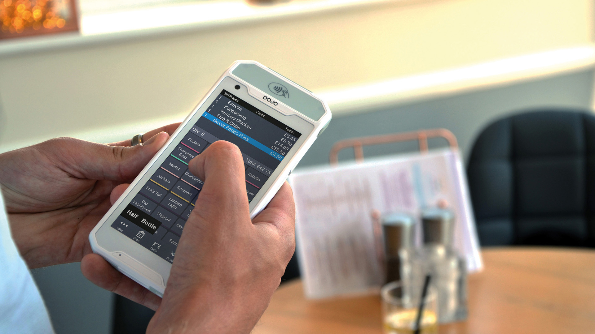 Waitress taking order on digital ordering pad outside
